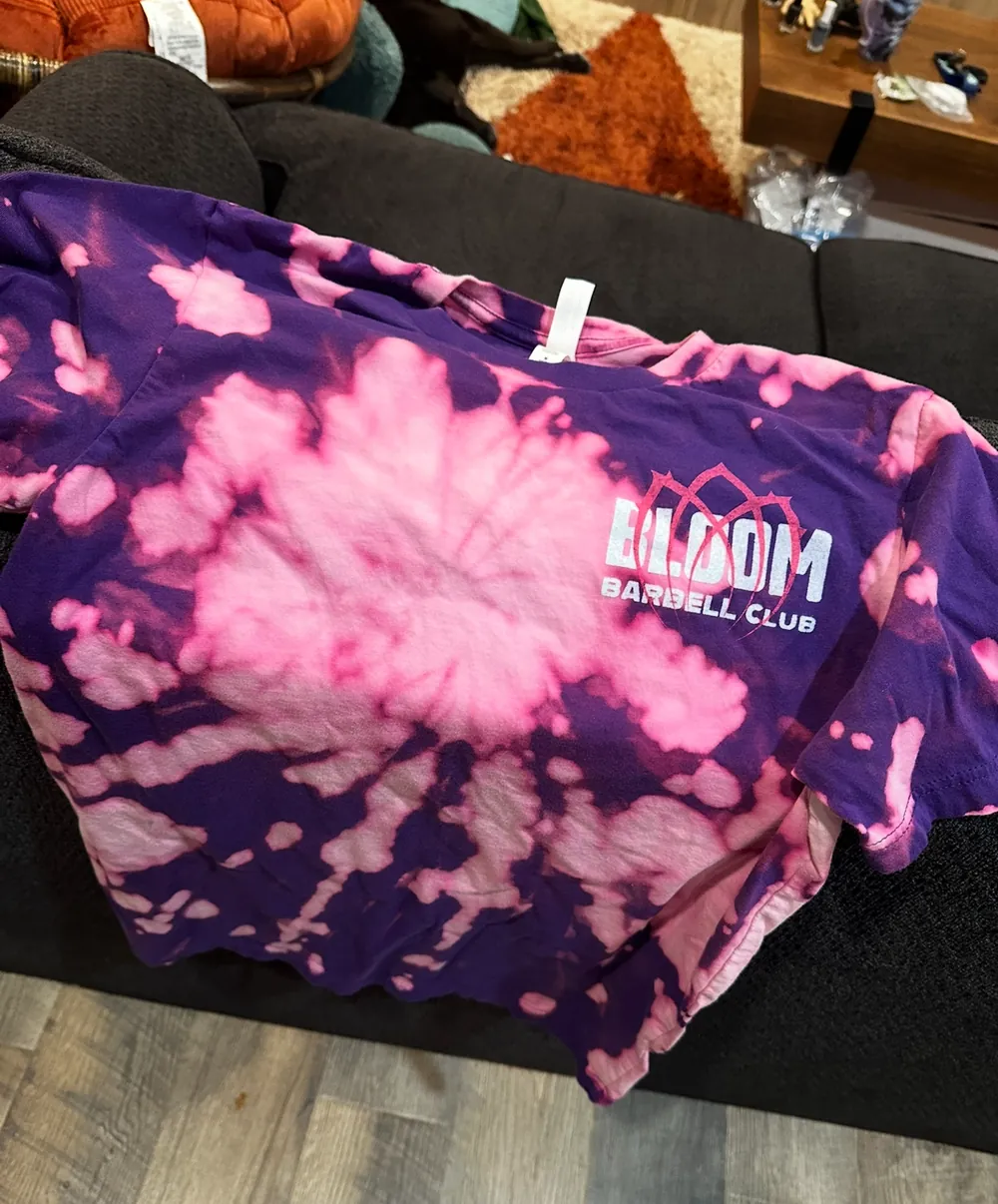 A purple and pink tie-dye Bloom Barbell Club shirt
